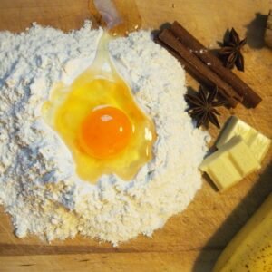 Flour with an egg yolk and baking ingredients on a table
