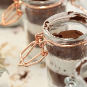 Jars of cocoa powder and chocolate dessert