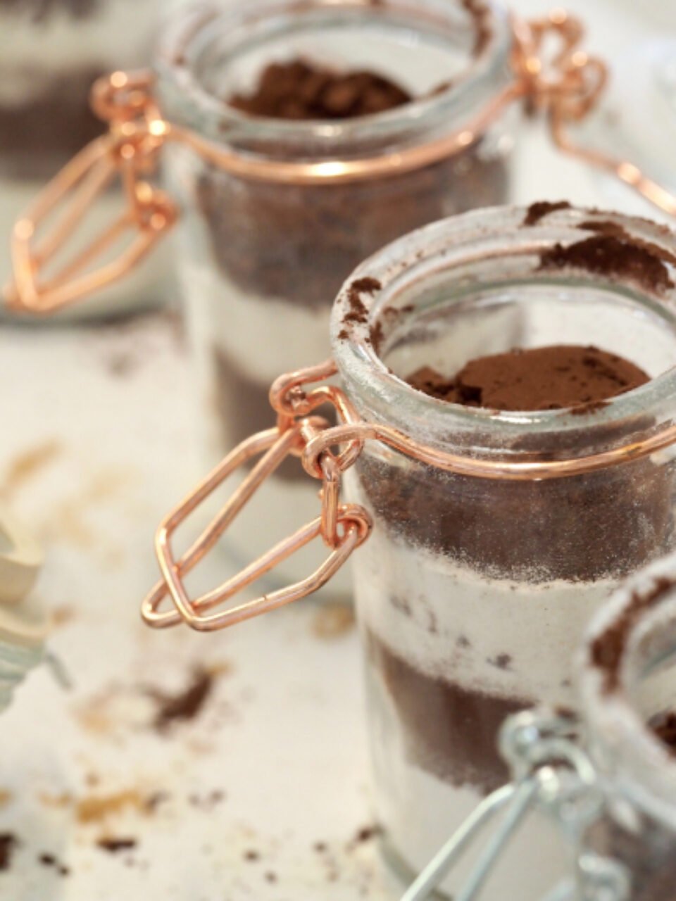 Jars of cocoa powder and chocolate dessert