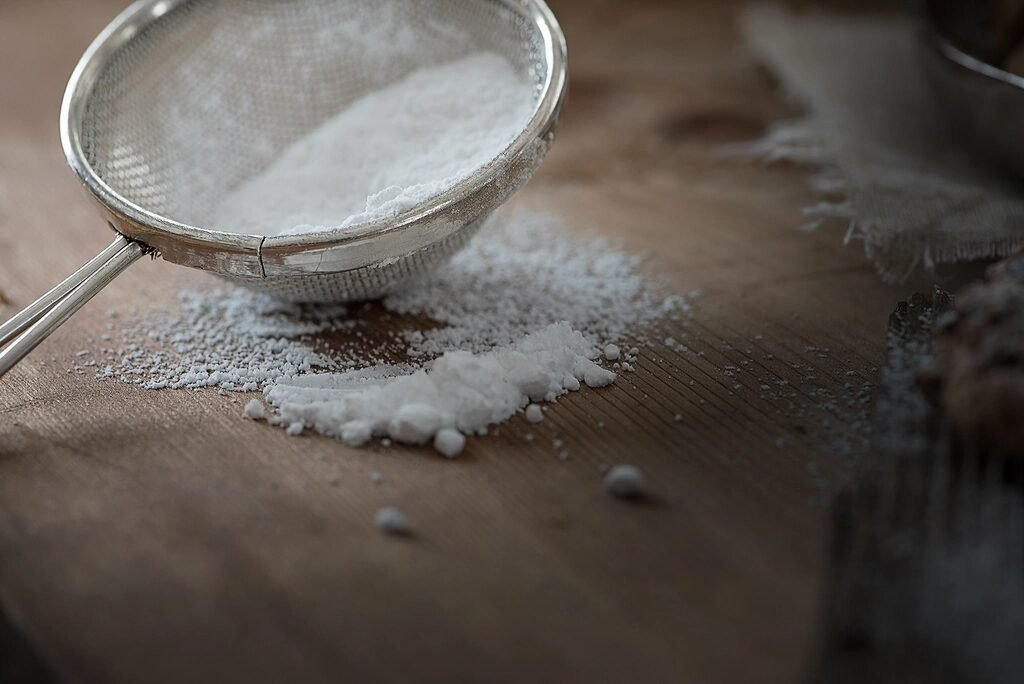 Fine mesh sieve dusting flour